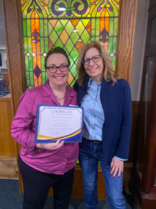 Iowa Democratic Party Chair Rita Hart presenting Pottawattamie County Democrats Chair Lisa Lima with the IDP's Rising Star Award at a regional event in Council Bluffs.